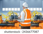 Small photo of Man industrialist. Factory worker with laptop. Specialist sets up industrial equipment. Man works in automated factory. Robotic manufactory inside hangar. Industrial equipment programming