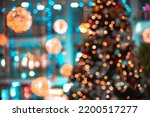 Decorated shopping mall Christmas eve festive time unfocused abstraction concept with bokeh lights on Christmas tree and walls, vibrant bright colors 