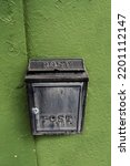 Small photo of Old metal mailbox on a green wall. Retry style.