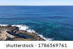 Small photo of Selective focus view of beautiful landscape of cliff, ocean, blue sea and rocky shore in nice weather. Bogey hole was constructed by order of Commandant Morisset in about 1820.