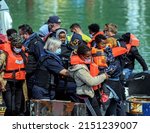 Small photo of Dover, Kent, UK, April 30th 2022. Migrants arriving at the port of Dover with Border Force officals after being rescued at sea in the English channel, attempting to seek asylum.