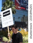 Small photo of Los Angeles, California, United States, July 14, 2023. SAG - AFTRA union member holding a sign about AI, on strike, and marching on the picket line, outside of NETFLIX Studios.