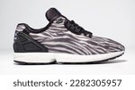 Small photo of kent, uk 01.01.2023 RARE ADIDAS torsion zx FLUX DECON zebra print basketball and sport trainers , stylish retro football street fashion. famous 3 stripes torsion trademark. famous three stripes brand