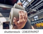 Small photo of Hand carrying cotton rolls in a weaving factory, machine weaving cotton for the fashion and textiles industry. Yarn weave traditional textile fabric manufacturing for clothing