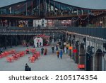 Small photo of London, UK - January 01, 2022: High angle view of people walking past the shops in Coal Drops Yard, a shopping destination and foodie hotspot near King's Cross station opened in 2018.