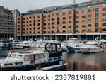 Small photo of London, UK - July 06, 2023: Boats and yachts moored in St Katharine Docks, a former dock and now a mixed-used district and London's only marina in Central London.
