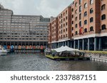 Small photo of London, UK - July 06, 2023: View of Cloister Walk in St Katharine Docks, a former dock and now a mixed-used district and London's only marina in Central London.
