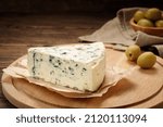 Tasty blue cheese on wooden table.