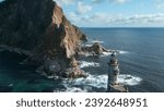 Small photo of Top view of beautiful rocky cape with lighthouse. Clip. Cinematic landscape of rocky cape and lighthouse with sea waves. Rocky cape with abandoned lighthouse in sea on sunny summer day
