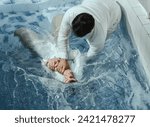 Small photo of A Protestant pastor baptizes a man in water in the name of Jesus Christ