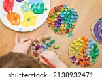 Painting of natural goods. Children's brush painting on touch surfaces glued to paper. Play at home the other way around. Do-it-yourself tasks for children. Activities for little ones.