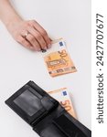 Small photo of Woman takes money from a man wallet. Barracuda takes paper banknotes stolen from some person. Family financial literacy, loans, savings and taxes. Cash machinations, unplanned expenses, Euro currency