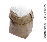 Small photo of Mineral nitrogen fertilizer urea, isolated on a white background in a bag. Ammonium nitrate in a sack on a white background. Urea granules in a bag isolated on a white background.