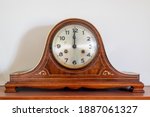 Close up of an antique clock showing 12 oclock