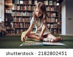 Small photo of Child solving riddle in book in school library. Primary school pupil is involved in book with riddles. Smart girl learning to solve problems. Benefits of everyday practice. Child curiosity