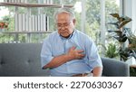 Small photo of Elderly Asian man with chest pain suffering from heart attack. Man clutching his chest from acute pain. Heart attack symptom-Healthcare and medical concept