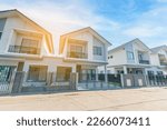 Small photo of Beautiful exterior of modern twin house just finished, Front View of New Residential house, the architectural design of the exterior with blue sky, The concept for Sale,Rent, Housing, and Real Estate.