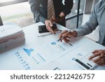 Small photo of Meeting of businesspeople point to graph and chart to analyze market data, balance sheet, accounts, net profit to devise new sales strategies to increase productivity.