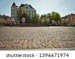 Cobblestone close-up. Sharpness on granite tile. Square and street are blurred in the background. Layout for design. The area is removed from the lower angle.