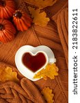 Small photo of Autumn still life. Oak leaves, heart cup on knitted scarf or plaid. Concept of autumn resing time, romantic, hygge, unplug, mindfulness, Warm, cozy, rustic style home decor, copy space, banner
