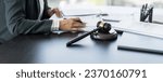 Small photo of Lawyer businessman working with lawbook in office or courtroom Legal counsel with gavel and legal law. justice and lawyer concept Judge gavel hammer on Lawyer desk