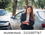 Small photo of Asian woman, notify insurance agents is writing an accident car crash report, to people and transportation insurance concept.