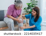 Small photo of Physical therapist Asian woman, doing leg physiotherapy for elderly woman, to treat osteoarthritis and nerve pain in the leg, to nursing home and health care concept.