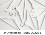 White wooden clothes hangers and coat hangers on a white background.
Sale and shopping concept.