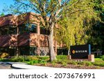 Small photo of Rivian sign logo at headquarters in Silicon Valley. Rivian is an American electric vehicle automaker and automotive technology company - Palo Alto, California, USA - 2021