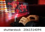 Small photo of Fake news on computer screen. Broadcast, trolling, false information, hoax, propaganda, information and disinformation abstract concept 3d with glitch effect. Man typing keyboard.