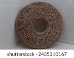 Small photo of A detailed image capturing a perforated pottery disk from Mohenjo-Daro, with intricate patterns, used perhaps for grain processing or as a household tool, displayed against a white backdrop