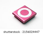 Small photo of Saint-Petersburg, Russia - May 10, 2022: Pink music player with big round button. iPod shuffle for girls