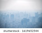 Small photo of TOKYO, JAPAN - March 27, 2019: dust during daytime in a very polluted city - in this case Tokyo, Japan. Cityscape of buildings with bad weather from Fine Particulate Matter. Air pollution.