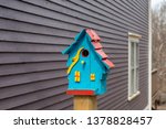 A Small Blue Birdhouse With A...