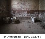 Three Old Toilets In The...