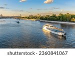 Small photo of Cruise ship sails on the Moscow river in Moscow city center, popular place for walking. Panoramic view of Moscow river with cruise boat