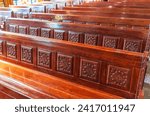 Small photo of Empty wooden church benches of a Christian church. Blurry alter in the background. Selective focus. Concept of church service or empty churches. Rows of church benches. Beautiful background