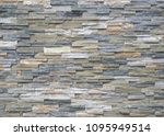 Quartzite natural stone cladding for external walls with bricks of different colors. Background and texture