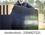 Small photo of Person holding a set of several new solar panels