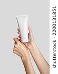 Small photo of Woman hand showing cream product. Cosmetic product branding mockup. Daily skincare and body care routine. Female hand holding cosmetic product mockup, close up.