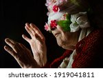 Small photo of Blindfold on the eyes of an old grandmother close-up. A bandage with flowers on the eyes of an old woman. Delusion concept. Cheating old people. Delusion. The concept of time heals. Granny in the dark