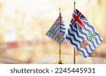 Small photo of Small flags of the British Indian Ocean Territory on an abstract blurry background.