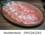 A plate of thin sliced pork meat (pork neck or pork blade shoulder) prepared for shabu or sukiyaki or Japanese hot pot. Selective focus.