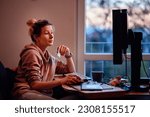 Small photo of Young woman with funny ponytail sits before computer and do online shopping in homeward