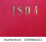 The year 1894 printed in gold on the red cloth binding of a yearbook published that year