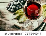red wine and grapes. Wine and grapes in vintage setting with corks on wooden table