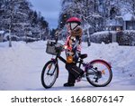 Girl On A Bicycle In A Winter...
