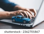 Small photo of Close-up of a small red car on laptop keypad. Planning to manage transportation finance costs. Concept of car insurance business, saving buy with tax and loan for new car. Car loan contract