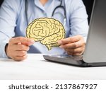 Small photo of Doctor holding a brain shape made from yellow paperl. Awareness of Alzheimer's, Parkinson's disease, dementia, stroke, seizure, or mental health. Neurology and Psychology care