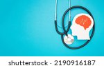 Small photo of A brain shape made from paper and a stethoscope on a light blue background. Awareness of Alzheimer's, Parkinson's, dementia, stroke, seizure, or mental health. Neurology and Psychology care